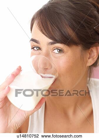 Young woman drinking glass of milk View Large Photo Image Stock Image - Young woman drinking glass of milk. Fotosearch