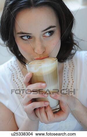 Young woman drinking Latte Macchiato View Large Photo Image Picture - Young woman drinking Latte Macchiato. Fotosearch