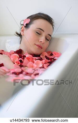 Young woman enjoying bath with rose petals View Large Photo Image Stock Image - Young woman enjoying bath with rose petals. Fotosearch