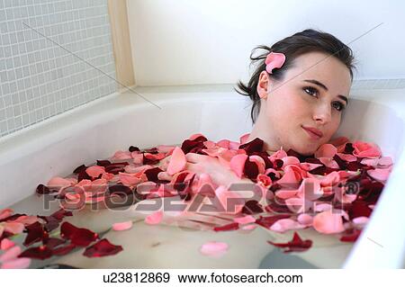 Young woman enjoying bath with rose petals View Large Photo Image Stock Photo - Young woman enjoying bath with rose petals. Fotosearch