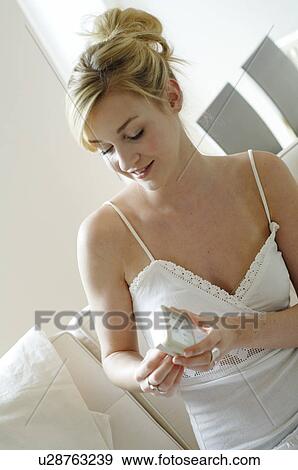 Young woman holding alarm clock View Large Photo Image Stock Photo - Young woman holding alarm clock. Fotosearch