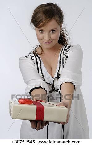 Stock Photography - Young woman holding gift box. Fotosearch