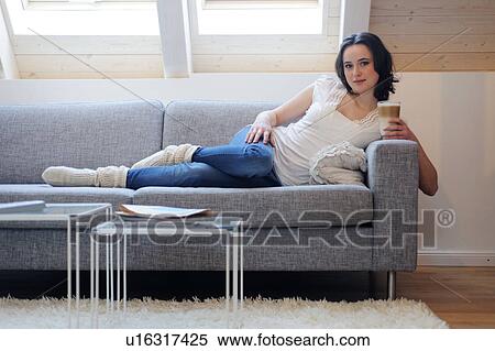 Young woman on couch drinking Latte Macchiato View Large Photo Image Stock Photography - Young woman on couch drinking Latte Macchiato. Fotosearch