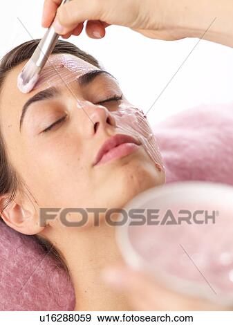 Stock Photo - Young woman receiving beauty treatment. Fotosearch