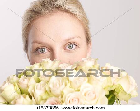 Young woman with bunch of roses View Large Photo Image Stock Photograph - Young woman with bunch of roses. Fotosearch