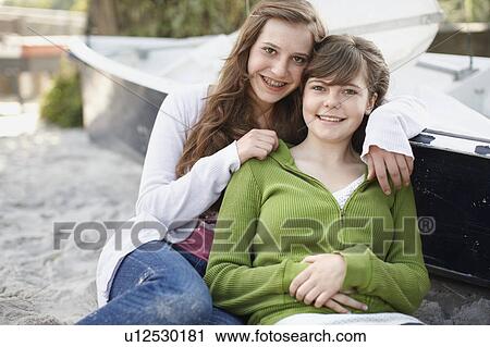 Stock Image - 2 girls having fun at the beach. Fotosearch