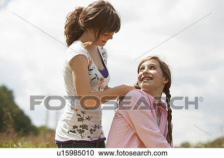 2 girls having fun together in a park View Large Photo Image Stock Image - 2 girls having fun together in a park. Fotosearch