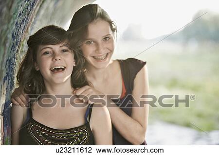 2 girls having fun together in a park View Large Photo Image Stock Image - 2 girls having fun together in a park. Fotosearch