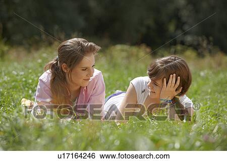 Stock Photograph - 2 girls having fun together in a park. Fotosearch
