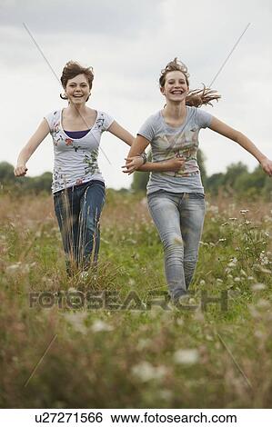 2 girls having fun together in a park View Large Photo Image Stock Photograph - 2 girls having fun together in a park. Fotosearch