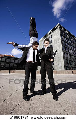 2 men negotiating one carrying a woman View Large Photo Image Stock Image - 2 men negotiating one carrying a woman. Fotosearch