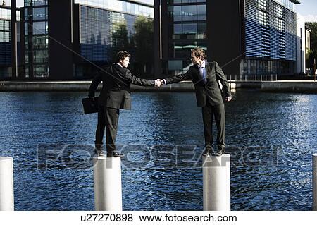 Stock Photo - 2 men shaking hands. Fotosearch