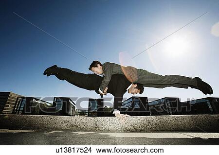 Picture - 2 men teamworking. Fotosearch