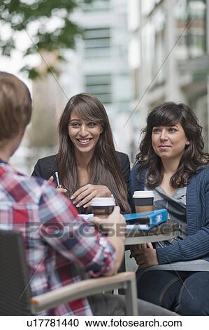 3 friends seated at cafe table View Large Photo Image Stock Image - 3 friends seated at cafe table. Fotosearch