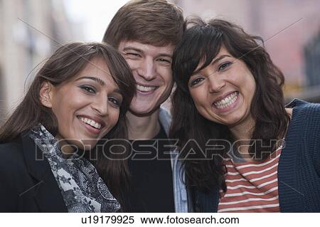 3 friends smiling to camera in street View Large Photo Image Stock Photography - 3 friends smiling to camera in street. Fotosearch