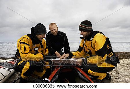 Stock Photography - 3 men looking at map. Fotosearch