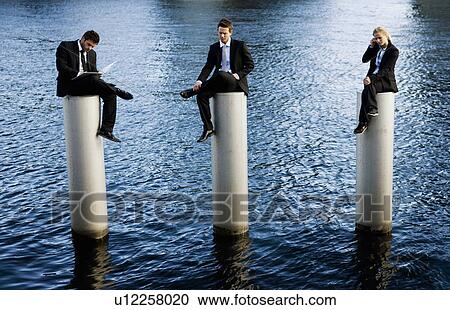 3 People on poles View Large Photo Image Stock Image - 3 People on poles. Fotosearch