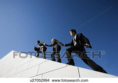 Picture - 3 people on roof. Fotosearch