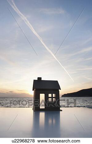 A cardboard house set against a sunset View Large Photo Image Stock Photo - A cardboard house set against a sunset. Fotosearch