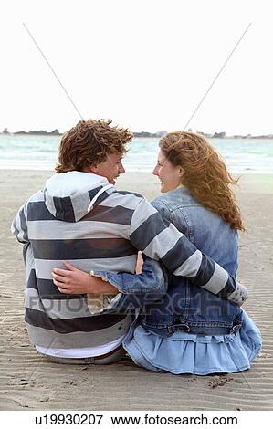 Stock Photo - A couple enjoying a deserted beach. Fotosearch