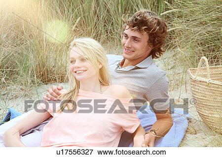 A couple having a romantic beach picnic View Large Photo Image Stock Photo - A couple having a romantic beach picnic. Fotosearch