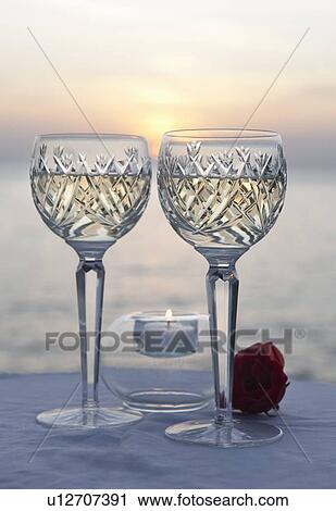 Stock Image - A couple of glasses of wine at sunset. Fotosearch