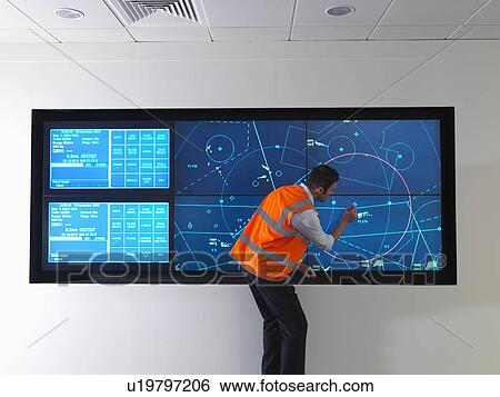 Stock Photograph - Air traffic controller with simulation. Fotosearch