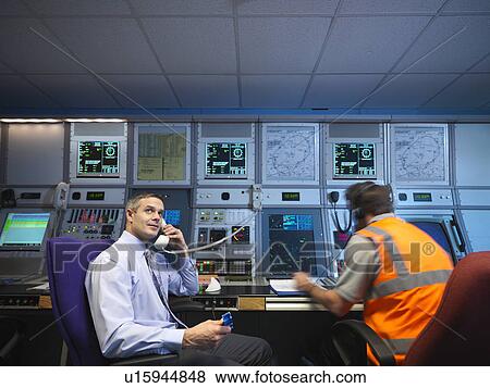 Stock Photo - Air traffic controllers in radar room. Fotosearch