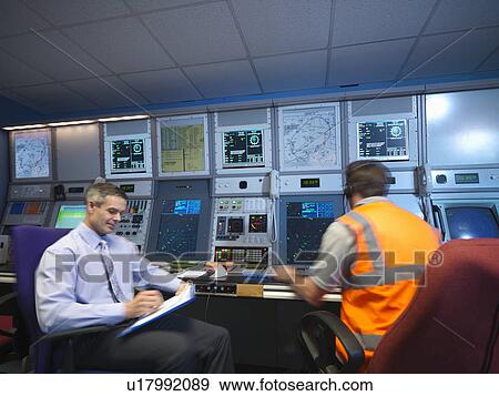 Stock Photo - Air traffic controllers in radar room. Fotosearch