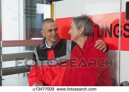 Ambulance man caring about woman View Large Photo Image Stock Photo - Ambulance man caring about woman. Fotosearch