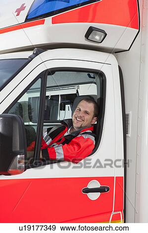 Stock Photo - Ambulance man in coach, smiling. Fotosearch