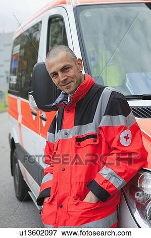 Stock Photo - Ambulance man in front of coach, happy. Fotosearch