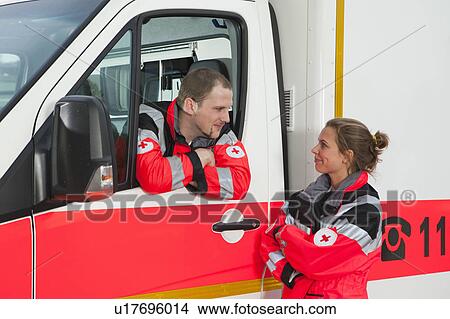 Ambulance man takling to collegue View Large Photo Image Picture - Ambulance man takling to collegue. Fotosearch
