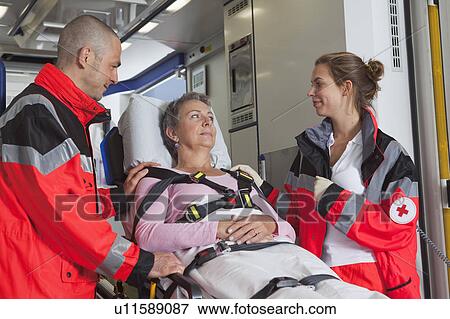 Ambulance team caring about woman View Large Photo Image Stock Photo - Ambulance team caring about woman. Fotosearch