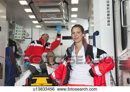Stock Photograph - Ambulance team with patient in coach. Fotosearch