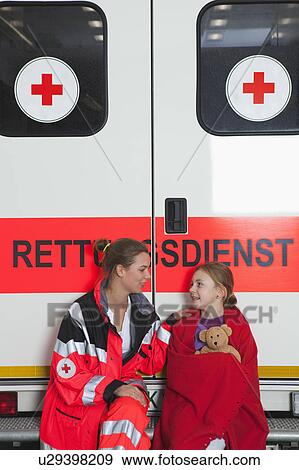 Ambulance woman calming girl at coach View Large Photo Image Stock Photo - Ambulance woman calming girl at coach. Fotosearch