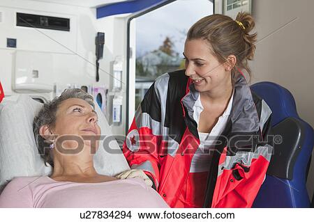 Ambulance woman caring about woman View Large Photo Image Picture - Ambulance woman caring about woman. Fotosearch