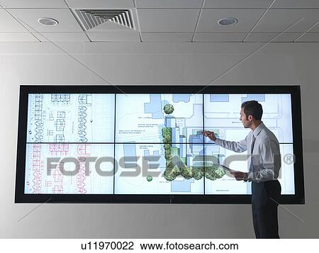 Stock Image - Architect works at plans on screen. Fotosearch