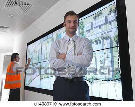 Stock Image - Architects with plans on screen. Fotosearch
