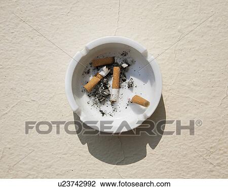 Stock Image - Astray with cigarette stubs. Fotosearch