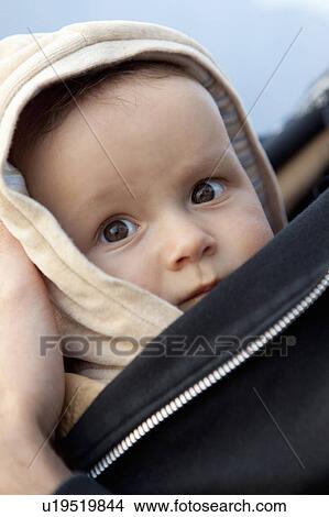 Picture - Baby in parent's arms. Fotosearch