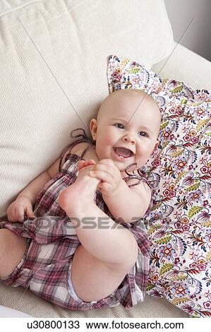 Baby laying on couch View Large Photo Image Stock Image - Baby laying on couch. Fotosearch