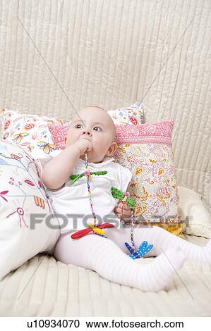 Baby sitting on bed View Large Photo Image Stock Image - Baby sitting on bed. Fotosearch