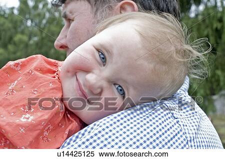 Baby smiling on Dad's shoulder View Large Photo Image Stock Photography - Baby smiling on Dad's shoulder. Fotosearch