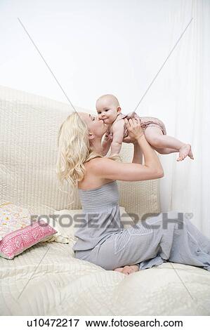 Baby with Mother in bed View Large Photo Image Stock Photo - Baby with Mother in bed. Fotosearch