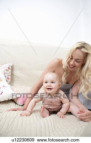 Baby with Mother in bed View Large Photo Image Stock Photo - Baby with Mother in bed. Fotosearch