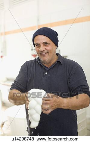 Bison mozzarella manual production View Large Photo Image Stock Photo - Bison mozzarella manual production. Fotosearch