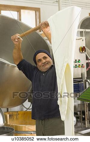 Stock Image - Bison mozzarella production. Fotosearch