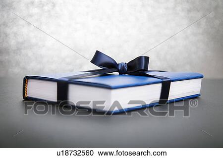 Stock Image - Book wrapped in blue paper. Fotosearch
