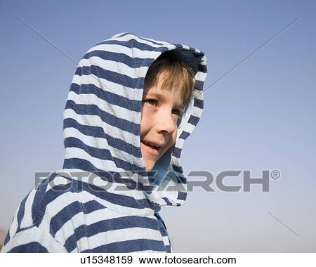 Boy (7-9) looking into distance View Large Photo Image Stock Photo - Boy (7-9) looking into distance. Fotosearch